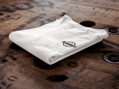 t-shirt-mockup-of-a-folded-t-shirt-over-a-wooden-surface-6485a-min
